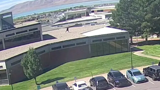 CCTV footage shows a man, wearing black clothes, running across the roof of a building.