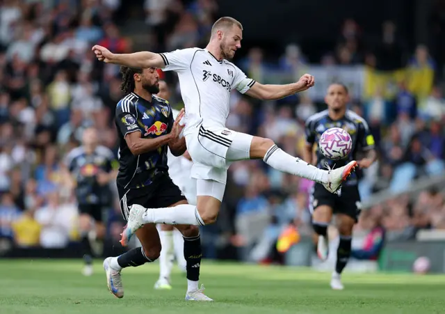 Joachim Andersen of Fulham is put under pressure by Dominic Calvert-Lewin of Leeds United during the Premier League match between Fulham and Leeds United at Craven Cottage on September 13, 2025 in London, England.