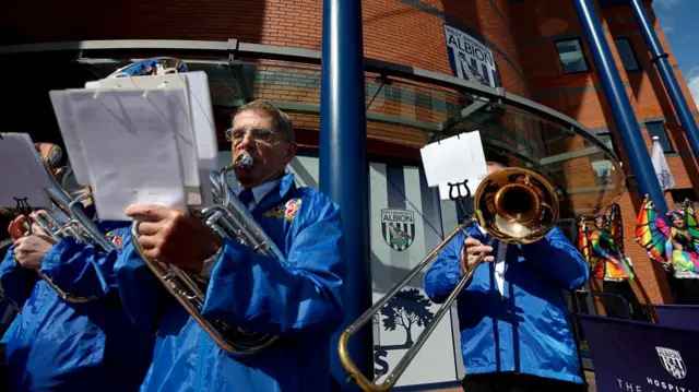 A brass band plays outside The Hawthorns