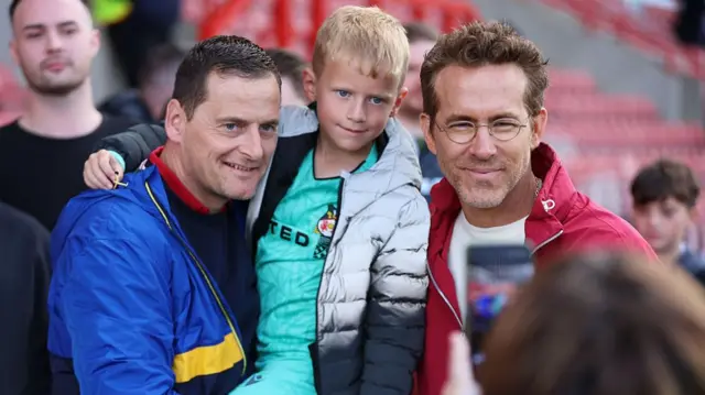 Wrexham owner Ryan Reynolds poses with fans before their game against QPR