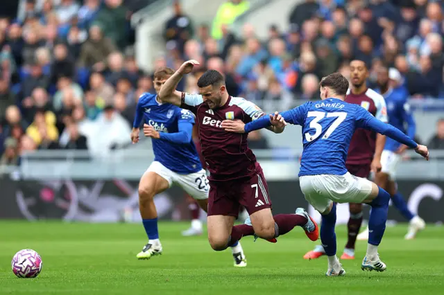 John McGinn of Aston Villa is challenged by James Garner of Everton during the Premier League match between Everton and Aston Villa at Hill Dickinson Stadium on September 13, 2025 in Liverpool, England.