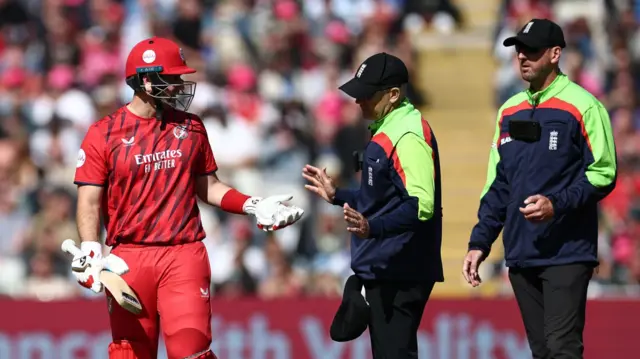 Liam Livingstone speaks to the umpires after being given out
