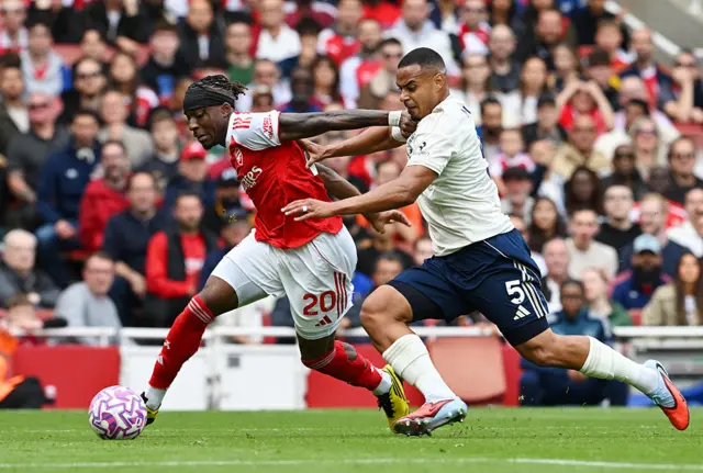 Noni Madueke of Arsenal is challenged by Murillo of Nottingham Forest during the Premier League match between Arsenal and Nottingham Forest at Emirates Stadium on September 13, 2025 in London, England.