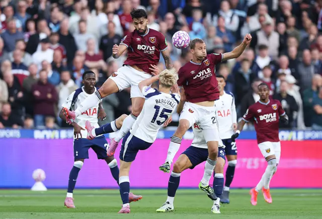 Lucas Paqueta and Tomas Soucek of West Ham United and Lucas Bergvall of Tottenham Hotspur battle for a header during the Premier League match between West Ham United and Tottenham Hotspur at London Stadium on September 13, 2025 in London, England.