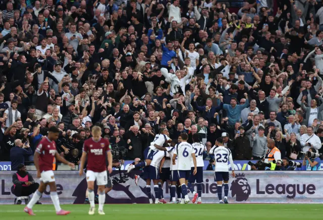 Tottenham Hotspur players celebrate in front of the fans after Micky van de Ven