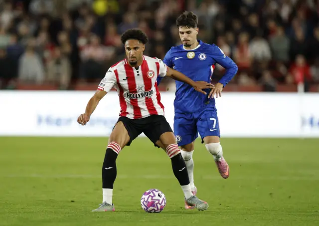 Brentford's Kevin Schade in action with Chelsea's Pedro Neto