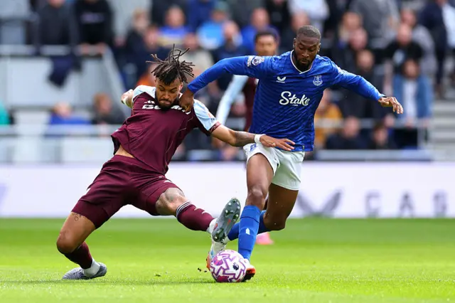 Tyrone Mings of Aston Villa challenges Beto of Everton before later going down with an injury during the Premier League match between Everton and Aston Villa at Hill Dickinson Stadium on September 13, 2025 in Liverpool, England.