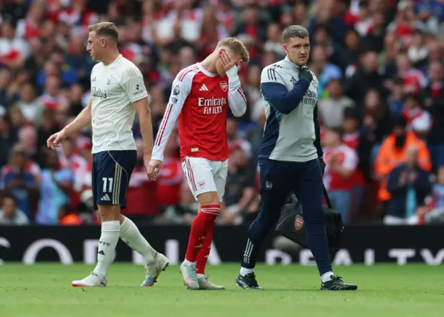 Arsenal's Martin Odegaard looks dejected after being substituted due to injury