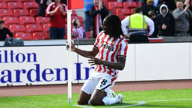 Bosun Lawal celebrates his goal for Stoke in front of the corner flag