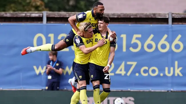 Oxford players celebrate with goalscorer Will Lankshear