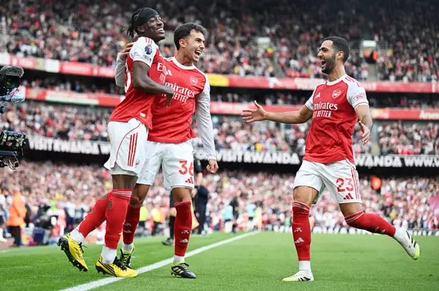 Martin Zubimendi celebrates scoring his team's first goal with teammates Noni Madueke and Mikel Merino of Arsenal during the Premier League match between Arsenal and Nottingham Forest at Emirates Stadium on September 13, 2025 in London, England.