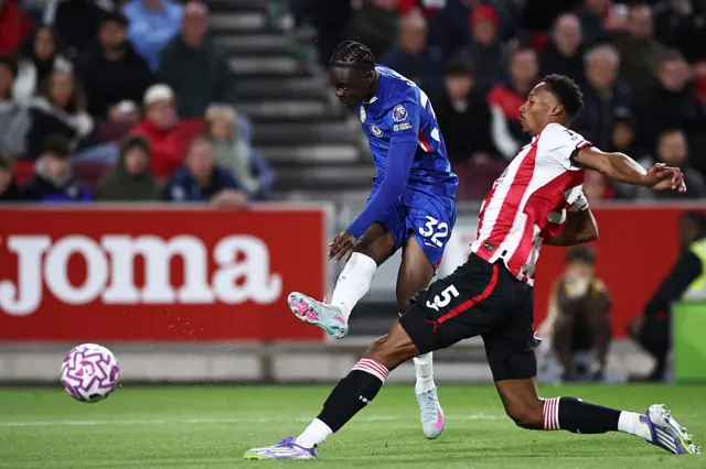 Chelsea's English midfielder #32 Tyrique George (L) takes a shot as Brentford's English-born Jamaican defender #05 Ethan Pinnock