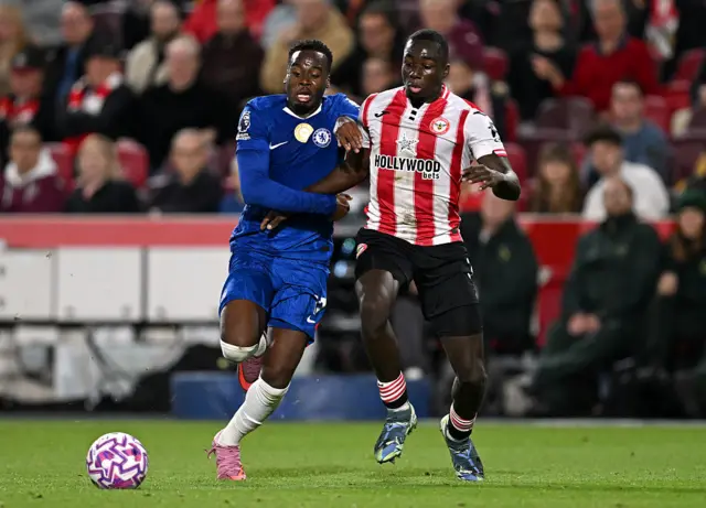 Jamie Gittens of Chelsea battles for possession with Michael Kayode of Brentford during the Premier League match between Brentford and Chelsea at Gtech Community Stadium on September 13, 2025 in Brentford, England.