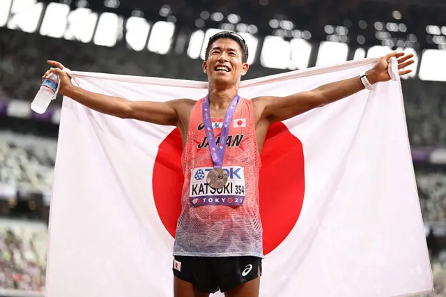 Hayato Katsuki celebrates winning the men's 32 kilometre race walk