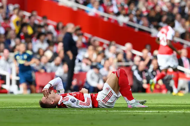 Martin Odegaard of Arsenal goes down with an injury during the Premier League match between Arsenal and Nottingham Forest at Emirates Stadium on September 13, 2025 in London, England.
