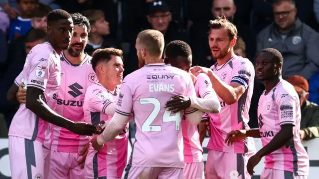 MK Dons players celebrate a goal