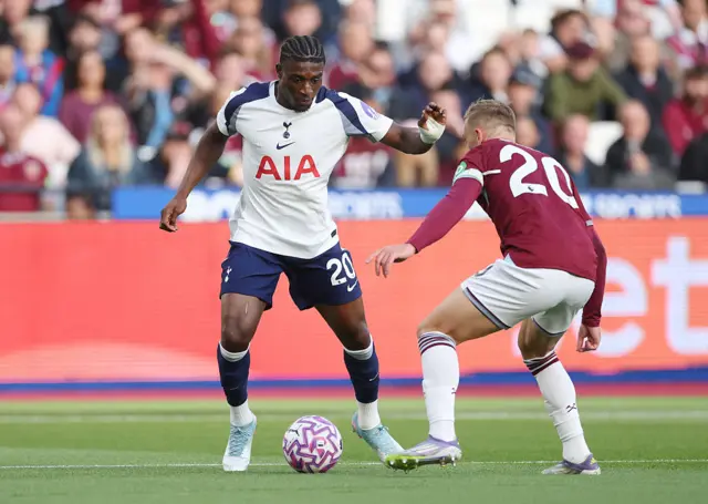 Mohammed Kudus of Tottenham Hotspur is challenged by Jarrod Bowen of West Ham United during the Premier League match between West Ham United and Tottenham Hotspur at London Stadium on September 13, 2025 in London, England.