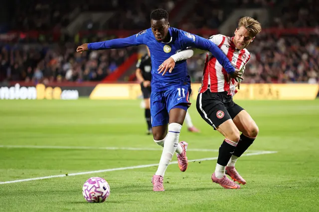 Jamie Gittens of Chelsea battles for possession with Mathias Jensen of Brentford during the Premier League match between Brentford and Chelsea at Gtech Community Stadium on September 13, 2025 in Brentford, England.