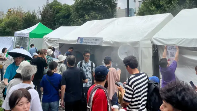 Cooling spots outside the stadium help fans cope in the heat