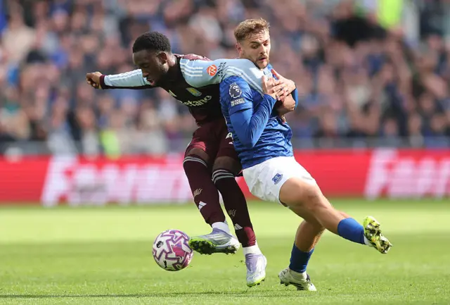 Lamare Bogarde of Aston Villa shields the ball from Kiernan Dewsbury-Hall of Everton during the Premier League match between Everton and Aston Villa at Hill Dickinson Stadium on September 13, 2025 in Liverpool, England.