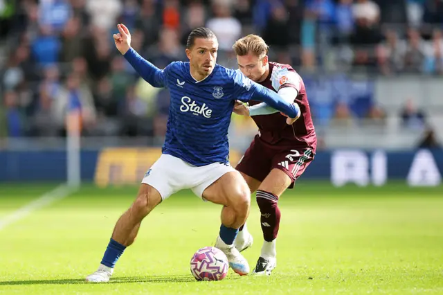Jack Grealish of Everton is challenged by Matty Cash of Aston Villa during the Premier League match between Everton and Aston Villa at Hill Dickinson Stadium on September 13, 2025 in Liverpool, England.