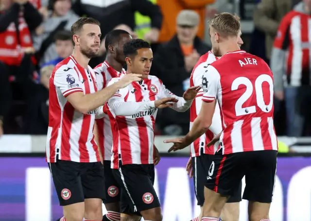 Brentford's Fabio Carvalho celebrates scoring their second goal with Jordan Henderson and Kristoffer Ajer