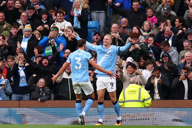 Erling Haaland of Manchester City celebrates with Ruben Dias