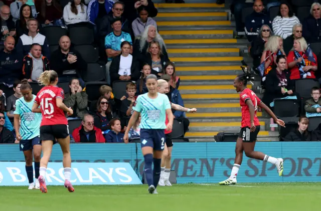 Manchester United's Melvine Malard (right) celebrates after scoring her sides fourth goal