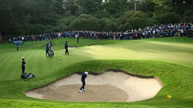 Rory McIlroy chips out of a bunker