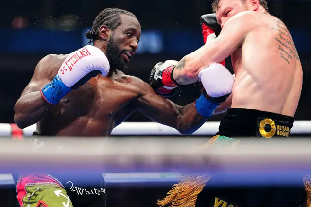 Terence Crawford sinks a punch into Saul Canelo Alvarez's body