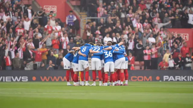 Portsmouth players huddle before kick-off