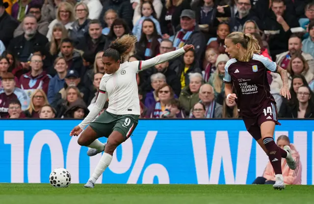 Catarina Macario of Chelsea passes the ball whilst under pressure from Lynn Wilms of Aston Villa during the Barclays Women's Super League match between Aston Villa and Chelsea FC at Villa Park on September 14, 2025 in Birmingham, England.