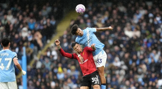 Manchester United's Benjamin Sesko and Manchester City's Nico O'Reilly battle for the ball