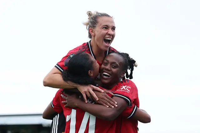 Jayde Riviere of Manchester United celebrates scoring her team's second goal with teammates Melvine Malard and Julia Zigiotti Olme