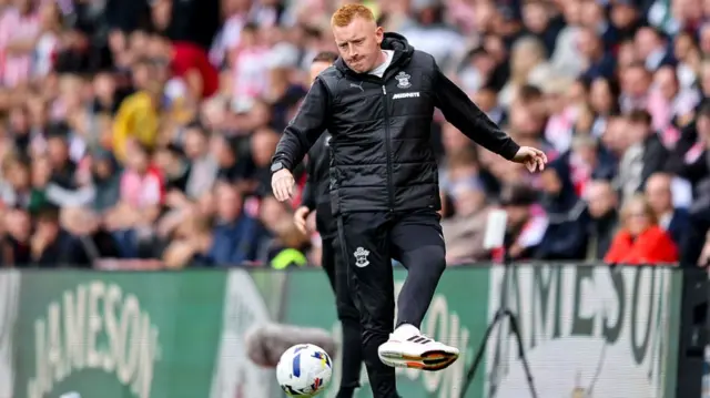 Will Still controls the ball on the touchline