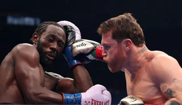 Terence Crawford blocks a shot from Saul Canelo Alvarez