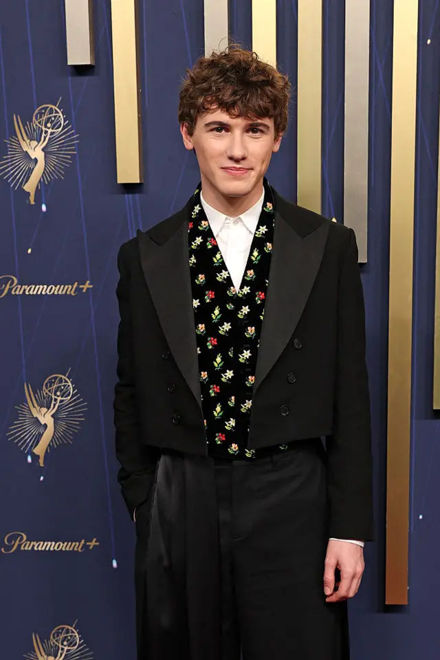 Sam Nivola from The White Lotus season three wears a black suit on the Emmys red carpet