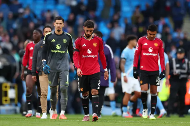 A dejected Bruno Fernandes, Casemiro and Altay Bayndr of Manchester Utd