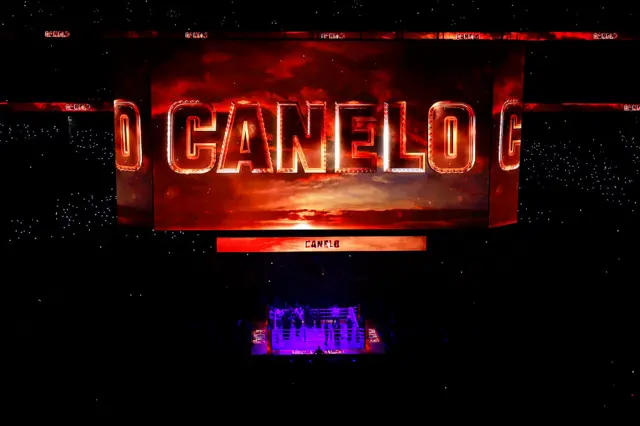 'Canelo' in red flames is across the big screen with the ring lit up below
