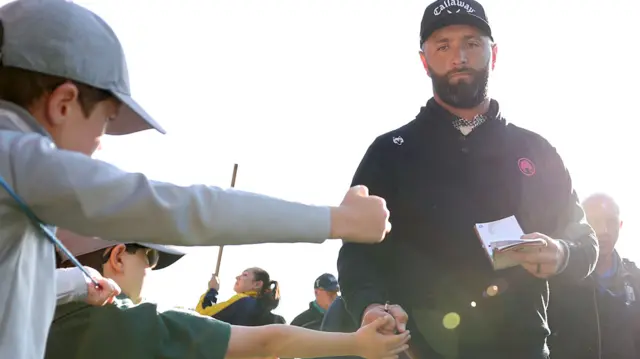 Jon Rahm fist-bumping a young fan during round two on Friday