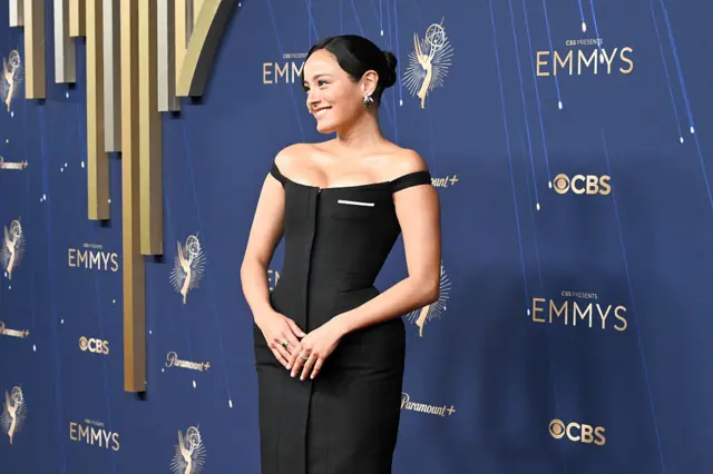 Chase Sui walks the red carpet in an off the shoulder black corset dress