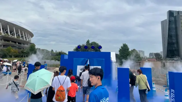 Spectators take advantage of the various cooling areas available outside the stadium