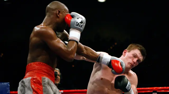 Two men box in a ring