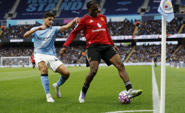 Manchester United's Patrick Dorgu in action with Manchester City's Abdukodir Khusanov