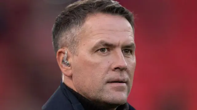 Michael Owen in a black coat