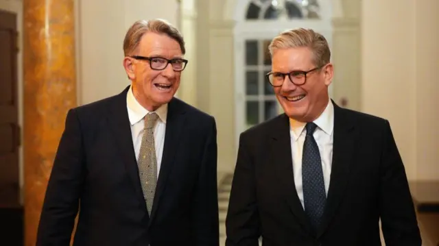 Prime Minister Sir Keir Starmer (right) and British ambassador to the United States Lord Peter Mandelson in suits, both smiling.