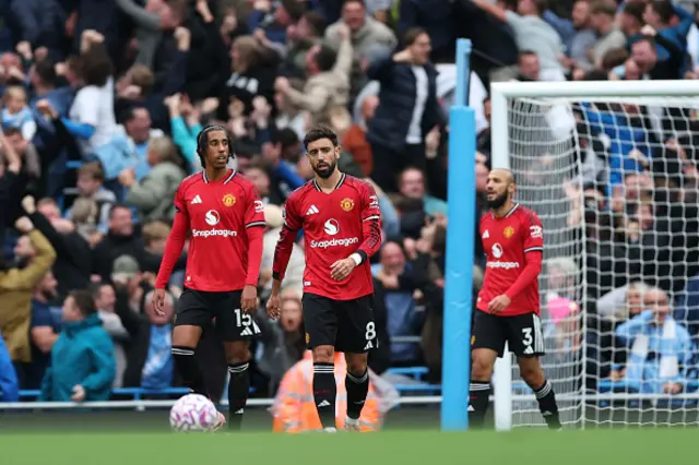 Leny Yoro and Bruno Fernandes of Manchester United react after Phil Foden of Manchester City (not pictured) scored