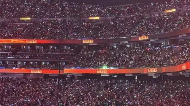 Fans with red, green and white LED bracelets light up Allegiant Stadium