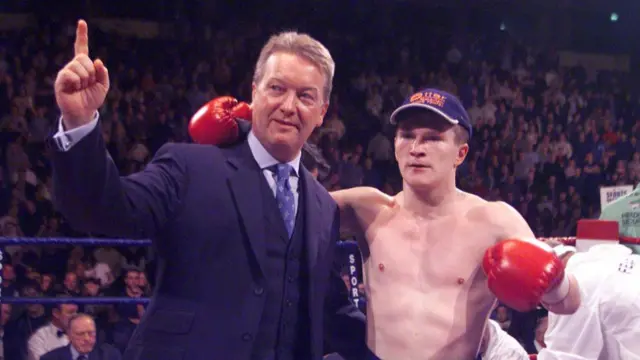 Ricky Hatton of Great Britain celebrates with promoter Frank Warren in boxing ring.