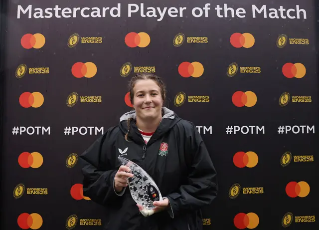 Morwenna Talling holding her player of the match trophy